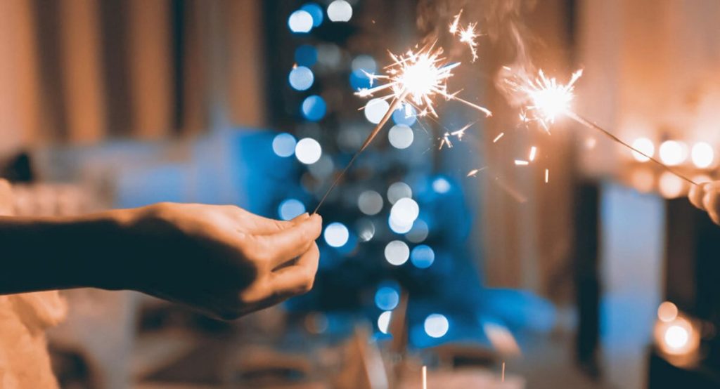 Close up of hands holding sparklers