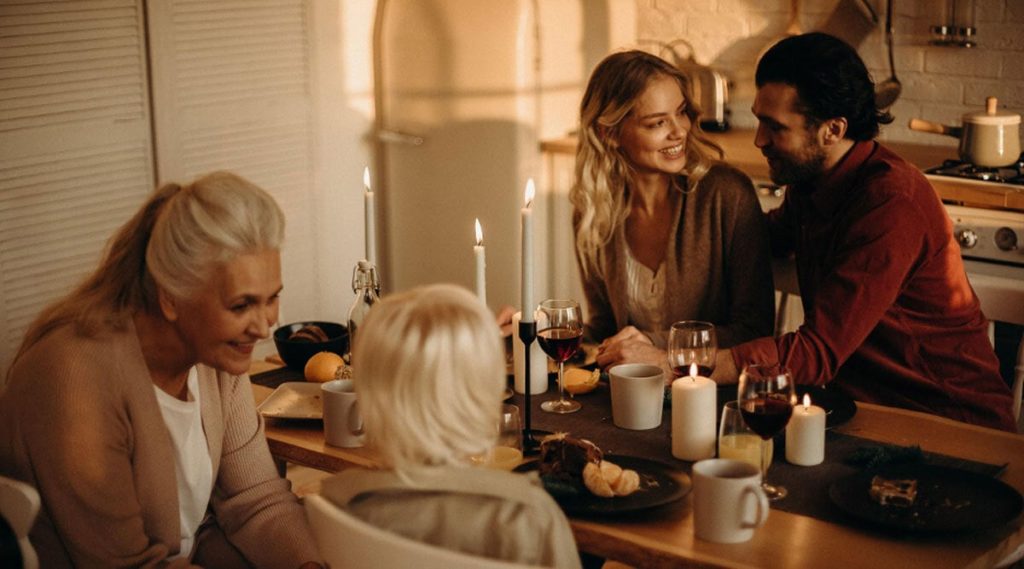 Family gathered around a table with candles