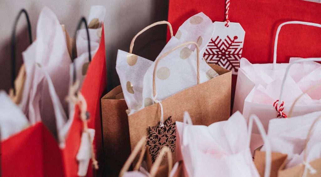 Brown and red gift bags with white tissue paper