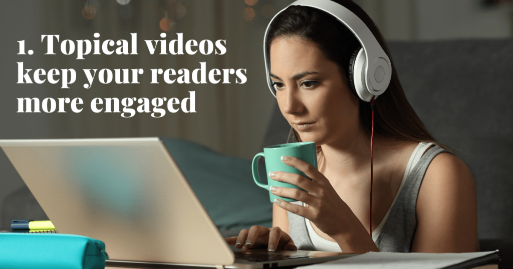 a girl with headphones on, holding a mug in front of a laptop