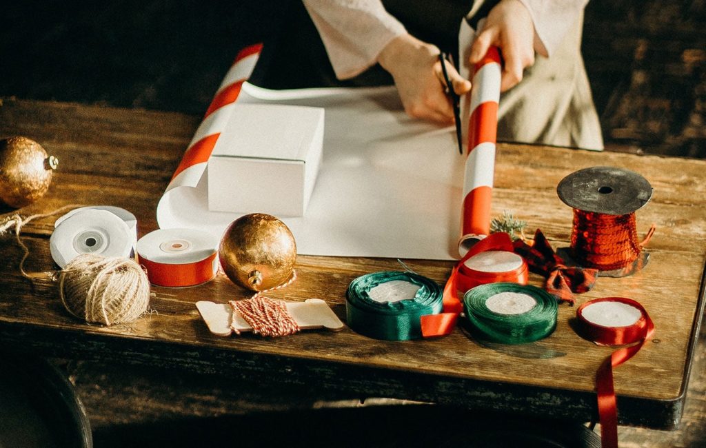 a top down view of someone wrapping a gift