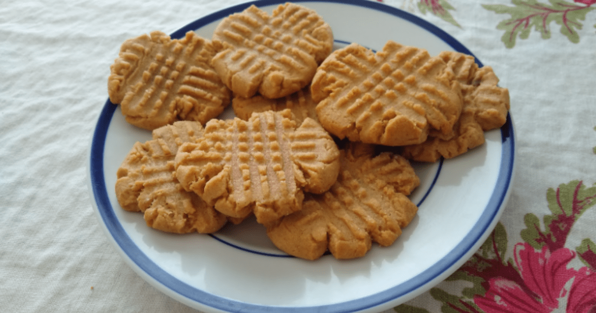 a plate of peanut butter cookies on a floral tablecloth