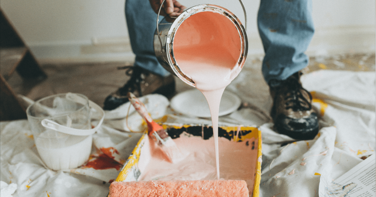 pouring paint into a sheet pan with a roller