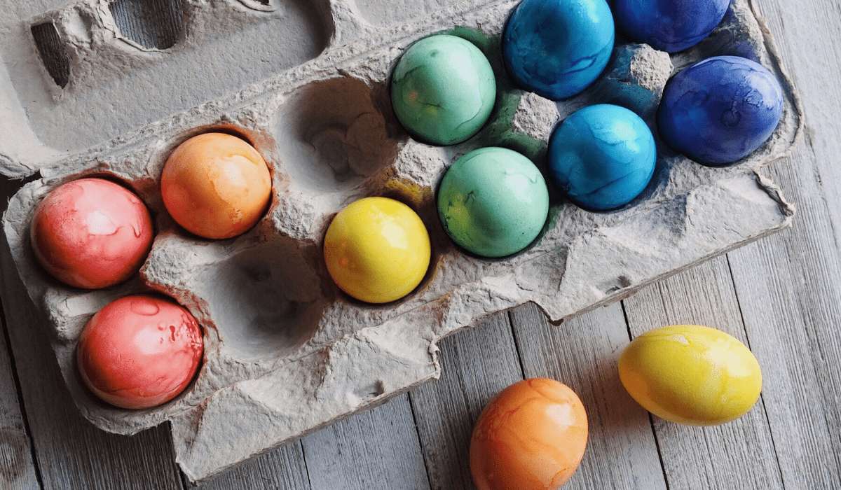 top down view of colorful easter eggs in a crate