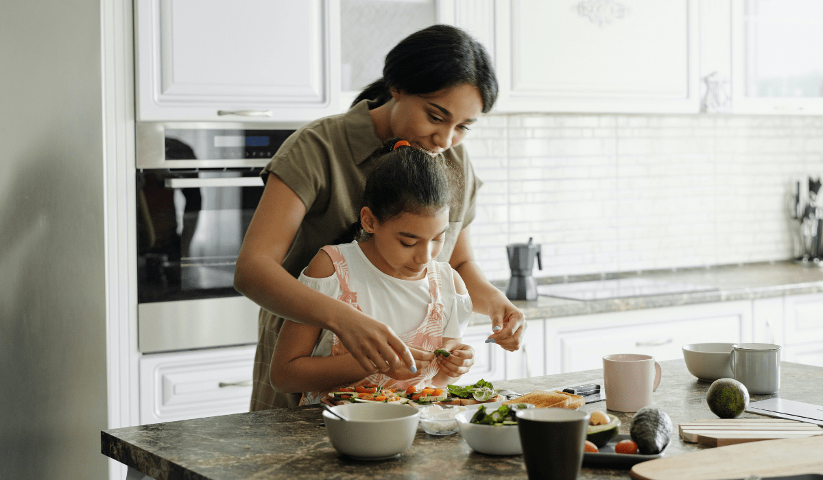 woman and girl in kitchen baking
