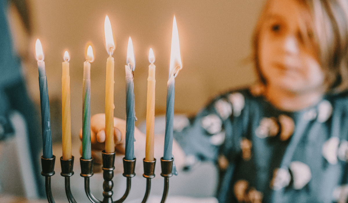closeup of a menorah and a kid in the background