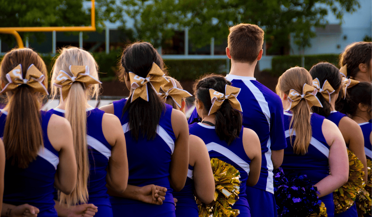 line of cheerleaders with poms