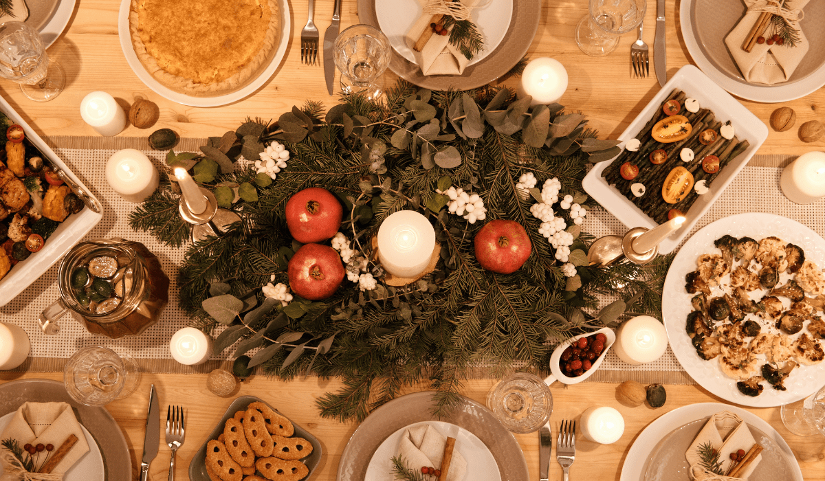 top down view of a holiday table with large greenery in the middle