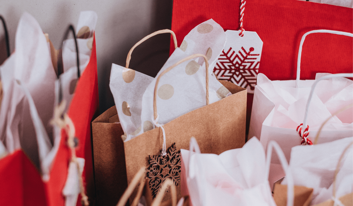 image of red bags of gifts with tissue paper