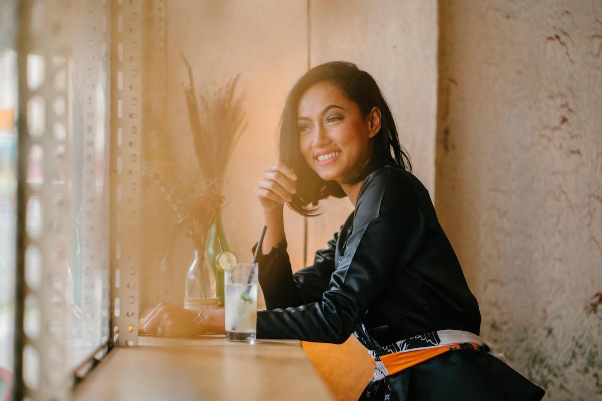 Image of a lady drinking a cocktail