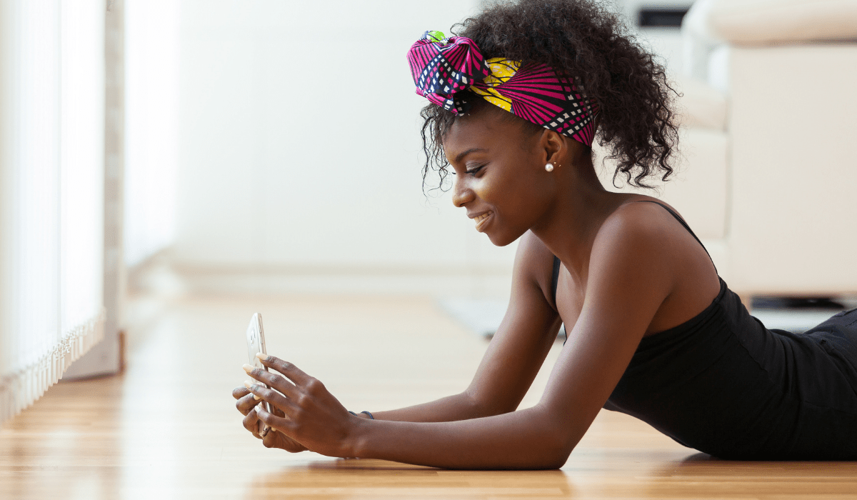 A person laying down looking at a mobile phone
