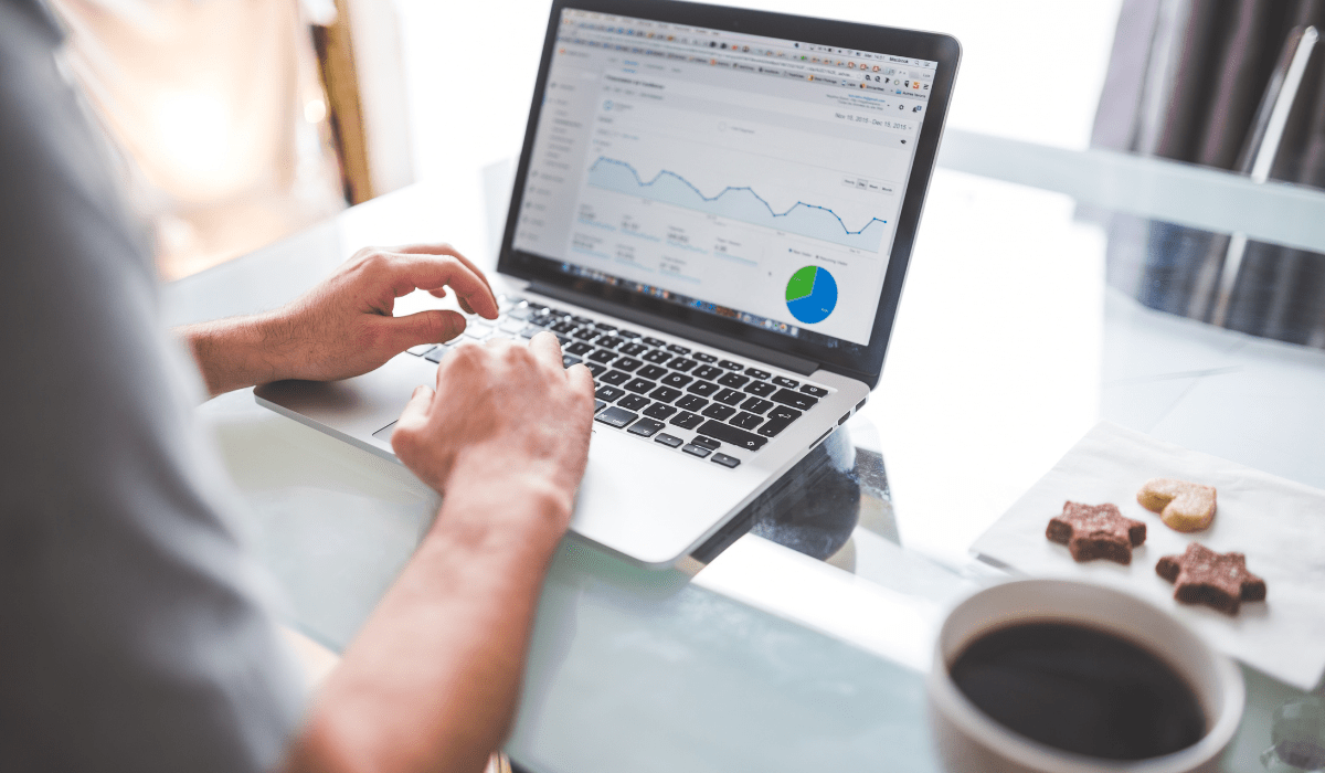 A closeup of someone working on a laptop with Google Analytics pulled up